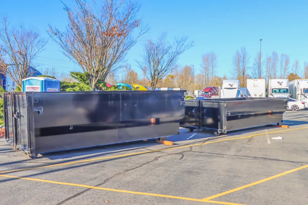 Professional dumpster rental service with roll-off container on residential driveway in Millville